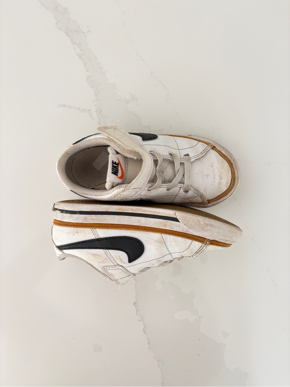 Nike White Kids Sneakers with Black Swoosh and Tan Accent
